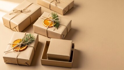 Minimal eco friendly Christmas gift boxes flat lay with kraft paper, twine, dried orange and copy space


