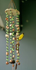 A sunbird building a nest in a wind chime.