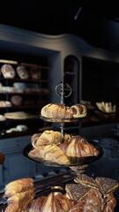 A display case on an old bakery counter is filled with a variety of freshly baked pastries.