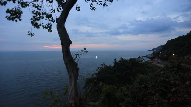 The video background depicts the waterfront, with twilight sky illuminating the riverside community and the lights from houses, reflecting the rural lifestyle of Chanthaburi, Thailand.