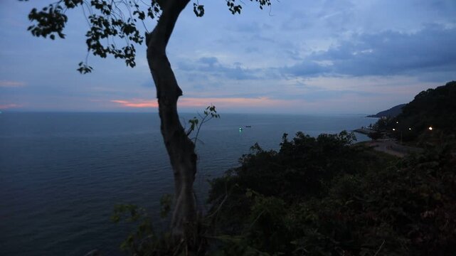The video background depicts the waterfront, with twilight sky illuminating the riverside community and the lights from houses, reflecting the rural lifestyle of Chanthaburi, Thailand.
