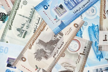 United Arab Emirates dirham currency money bills. The current banknotes lies on table in big amount close up