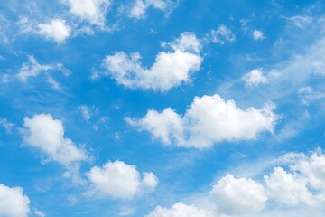 Fototapeta premium Beautiful blue sky with fluffy white cumulus and wispy cirrus clouds, isolated on white background