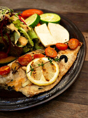 Grilled fish steak with mixed vegetable salad.