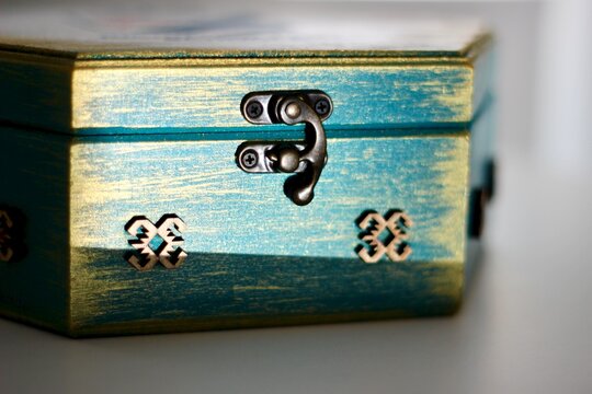 Close-up of a Rustic turquoise distressed wooden box with metal latch