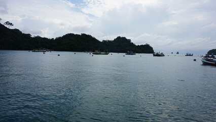 Colorful Fishing Boats Anchored in Calm Waters at Sendang Biru Beach, South Malang, East Java, Indonesia