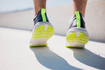 Person walking in sports shoes on a sunny surface