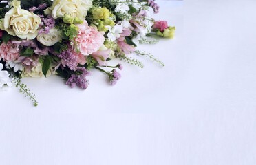 Festive bouquet of various colors on a white background with a place for text. Background for congratulations, invitations.	