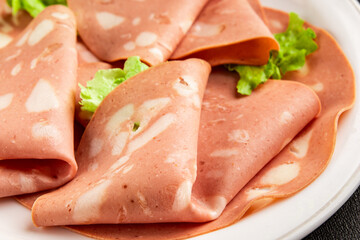 Mortadella sausage slices meat food tasty snack fresh delicious gourmet food background on the table rustic food top view copy space