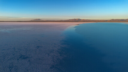 Sunset at the Uyuni Salt Flats. Reflections in the water. A beautiful salt lake. A colorful landscape.