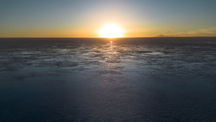 Sunset at the Uyuni Salt Flats. Reflections in the water. A beautiful salt lake. A colorful landscape.