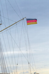 Fototapeta premium German national flag on historic sailing ship mast