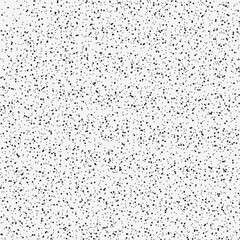 Seamless pattern of random black dots on a light grey background