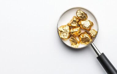 Pure gold nuggets magnifying glass white background top view wealth investment discovery