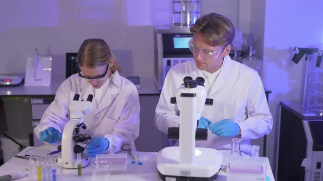 Students conduct science experiments in laboratory setting with microscopes