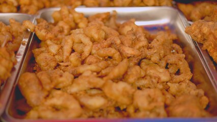 Fried chicken takeaway, golden fried chicken boxes prepared, vendor scoops crispy chicken into containers quickly, vendor serving freshly fried crispy chicken to customers in urban market setting