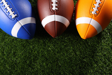 American football balls, rugby balls, different colours on grass and black backgrounds