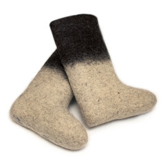 Felt boots with a light bottom and dark top lie on a white background
