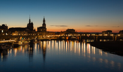  Dresden city skyline at Elbe river and Augustus Bridge at sunset , Dresden, Saxony, Germany. Panoramic evening view of Dresden.