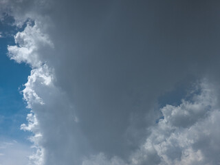 Dramatic clouds fill the sky above a serene outdoor landscape. The weather phenomenon creates an ominous yet peaceful atmosphere during the bright daytime.
