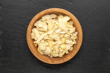 Peanuts sliced ​​on slate stone, top view.