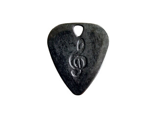 Metal guitar pick with treble clef engraving on transparent background