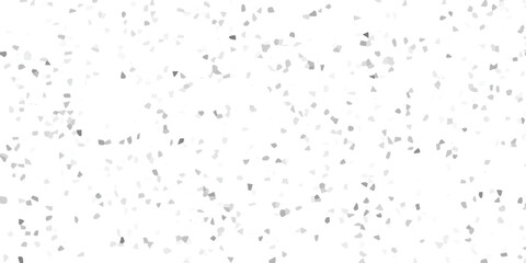 Textured abstract background featuring a random distribution of small, polygonal grey fragments on a bright white canvas, ideal for minimalist graphic design and digital art projects