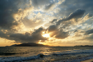 Beautiful sunrise over the ocean with dramatic clouds.