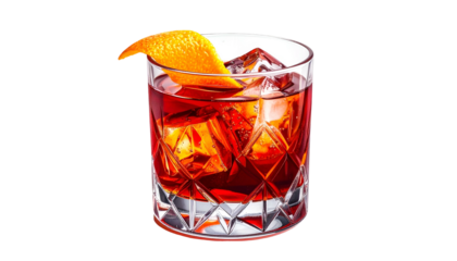 Classic cocktail in a cut-glass tumbler, garnished with an orange peel and ice