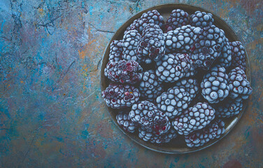 freshly frozen, blackberries on a plate, top view, no people,