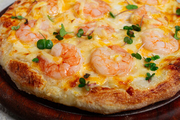 four cheese pizza with shrimp and fresh microgreens, served on a wooden board, homemade, no people,