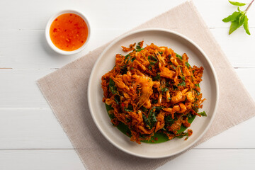 Thai Styled Shrimp Fritter with curry paste,Asian Street Food.Deep fried small shrimp with red curry paste and basil leaves.served with chilli dipping sauce.(goong tod prik gaeng).Top view.