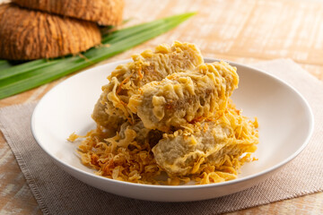 Deep-fried Unripe Rice Grain.Crispy coconut banana rolls in white plate.