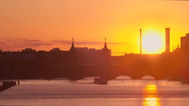 Underground train crossing Oberbaum Bridge at sunset, Spree River, Berlin, Germany