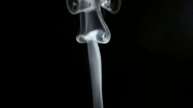 White smoke from a doused flame curling up into an abstract design, creating a fluid and ethereal background concept
