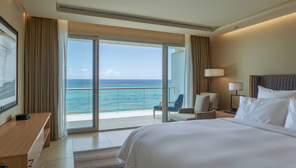 Fototapeta premium Luxurious hotel room with a stunning ocean view from the balcony and comfortable king-size bed