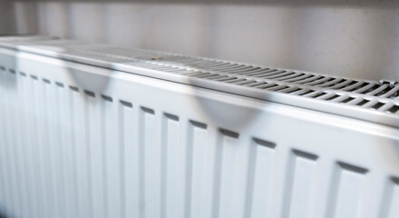 Radiator heating device installed in a home setting. Focus on the texture and details of the...