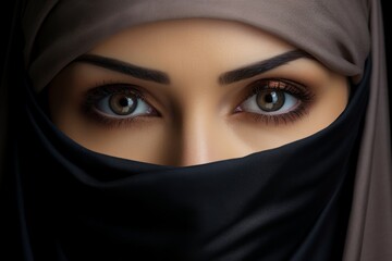 Beautiful close-up portrait of a woman in a black hijab showcasing her stunning eyes and serene expression