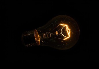 Brilliant, abstract glow of an electrical filament bulb illuminating darkness, symbolizing technology, inspiration, and sustainable energy ,illumination ,brilliant ,physics