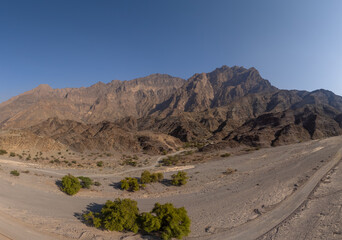 Large mountain next to a valley in Oman