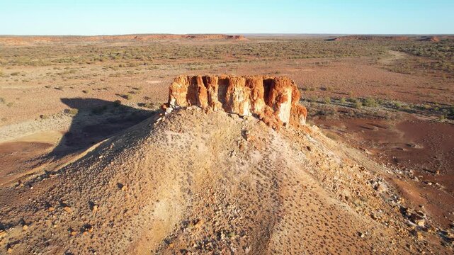 Aerial flight over geological formation in desert