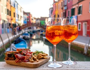 Two Aperol Spritz cocktails & antipasto platter overlooking a canal