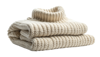 Folded beige turtleneck sweater on black. Warm, cozy knitwear stacked neatly