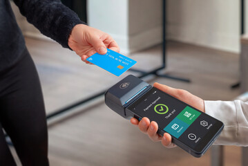 Contactless card payment approved on mobile POS terminal with digital interface options, illustrating modern retail technology and cashless checkout experience