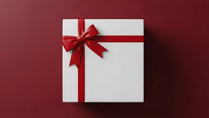 Elegant white gift box with red ribbon and bow on burgundy background