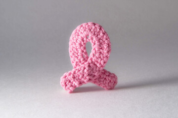 A knitted pink ribbon as a symbol of breast cancer prevention
