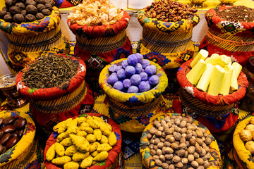 A vibrant display of traditional spices, frankincense, herbs, and natural ingredients arranged in woven baskets at Mutrah Souq in Muscat, Oman, showcasing authentic Omani market culture.