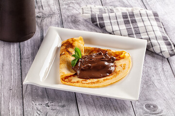Sweet pancake with chocolate paste