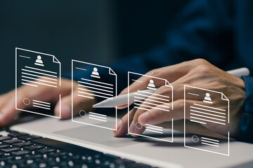 Hands reviewing multiple digital resumes on a laptop, representing candidate databases, recruitment systems, talent management, employee evaluation, and modern HR technology.