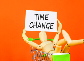 Time change symbol. Concept word Time change on beautiful white paper. Beautiful wooden clothespin. Businessman's model. Beautiful orange background. Business time change concept. Copy space.